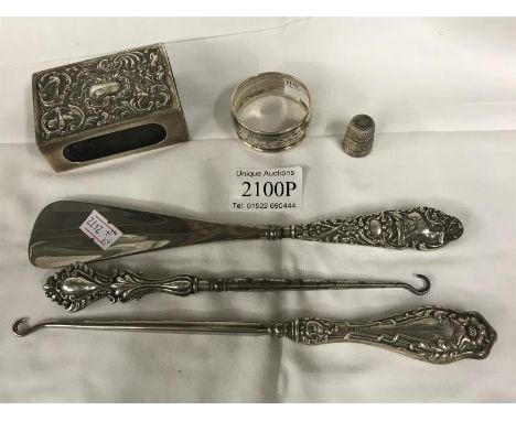 A silver match box holder, thimble, serviette ring, 2 silver handled button hooks and shoehorn. Gross weight 200g.