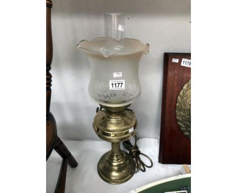 An electrical brass oil lamp with shade and chimney