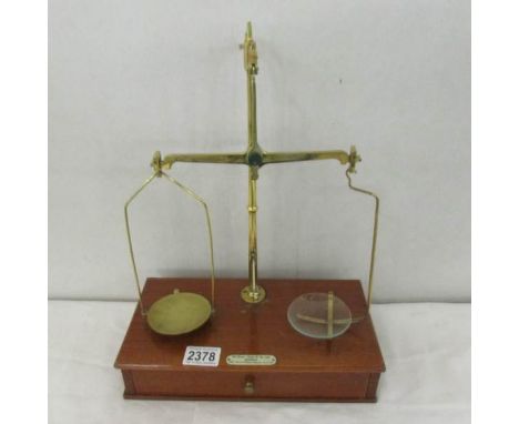 A set of brass beam scales with wooden drawer base.  de Grave, Short &amp; Co., Maker, 102 Naylor Road, London SE16.