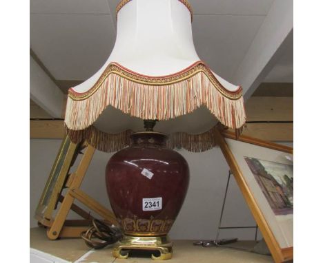 A pottery table lamp with shade.