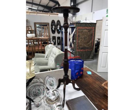 A tall mahogany tripod torchiere pot stand