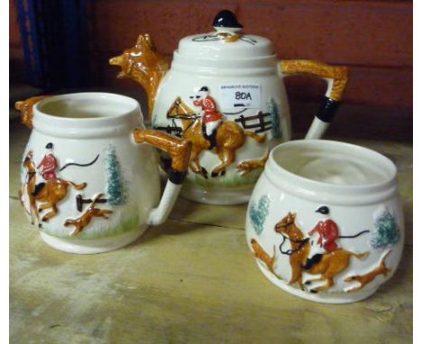 A Novelty Hunting Ware Three Piece Tea Service, the teapot and milk jug with fox mask handles (3)