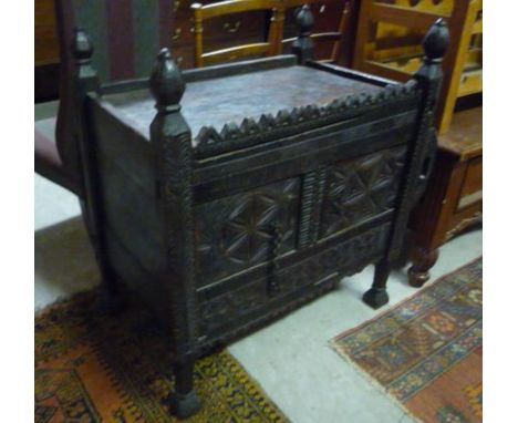 A Scandinavian Carved Tray-Top Cupboard with sliding door and standing on tapered pad supports.