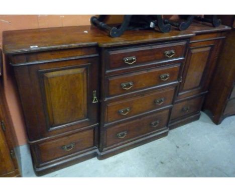 An Early to Mid 19th Century Breakfront Side Cabinet/Chest, with drawer and cupboard flanking four centre drawers. Provenance