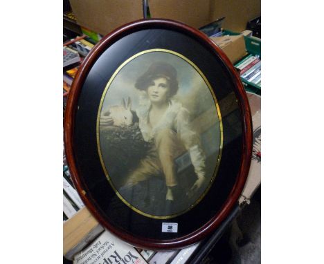 A Colour Print, Continental Boy Holding a Pet Rabbit, in oval eglomisé mount. 