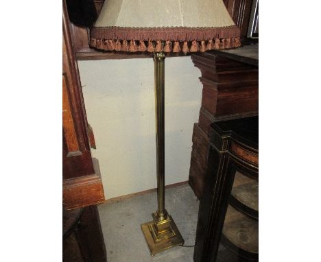 A Brass Corinthian Column Standard Lamp, the reeded column on square plinth base, with shade.