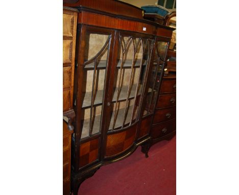 An early 20th century mahogany ledgeback bowfront single door glazed china display cabinet, raised on slender cabriole suppor