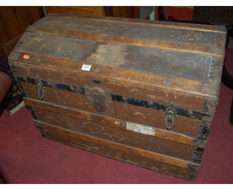 An early 20th century canvas clad, wood and metal bound hinged dome top travelling trunk, width 77cm
