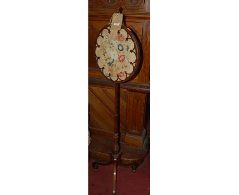 A Regency mahogany and satinwood strung pole screen, having a circular floral tapestry inset adjustable panel