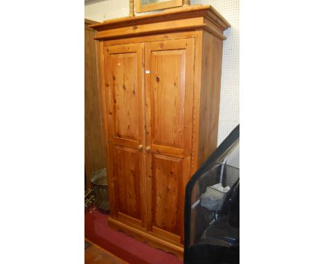 A modern pine double door wardrobe, w.104cm; together with a modern pine dressing mirror (2)