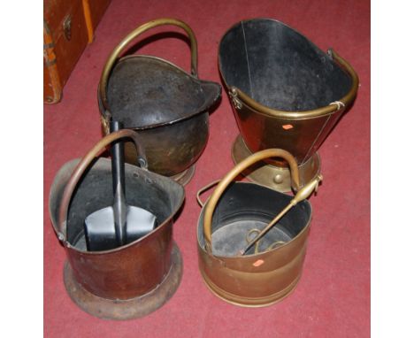 A collection of four various late 19th century brass helmet shaped coal scuttles, each having swing carry handles, with sundr