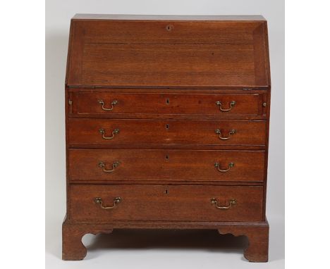 A George III oak bureau, the hinged fall revealing a fitted interior with four long graduated drawers below, raised on bracke