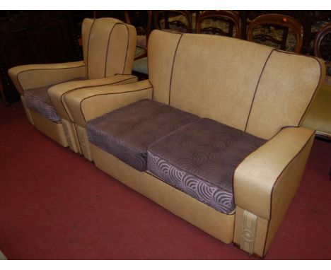 An Art Deco cream vinyl upholstered two-piece lounge suite, comprising two-seater sofa and matching armchair, each having bri