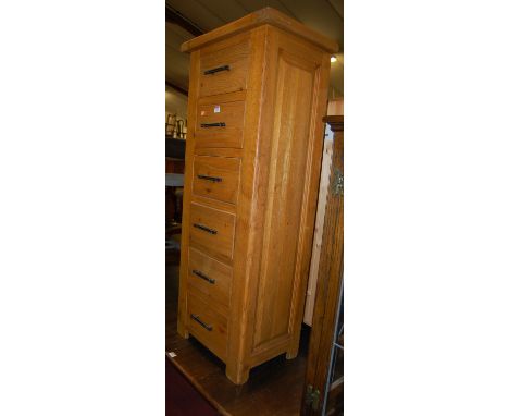A contemporary light oak narrow chest, of six long drawers, w.51.5cm