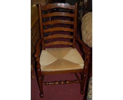 A set of four Lancashire type oak ladder back rush seat dining chairs (3+1)
