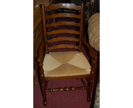 A set of four Lancashire type oak ladder back rush seat dining chairs (3+1)