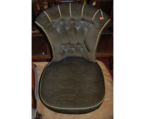 A Victorian walnut framed and green button back upholstered low nursing chair