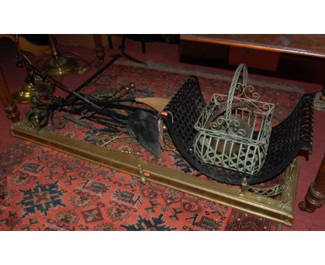 A collection of 19th century and later fireside metalwares, to include; brass kerb fender, log basket, fire tools on stand et