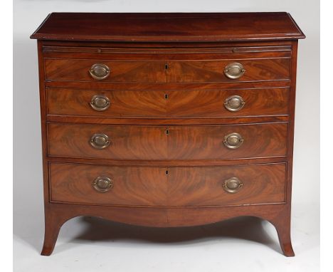 An early 19th century mahogany bowfront chest, having a brushing slide over four long graduated drawers, on splayed bracket f