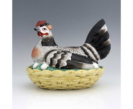 A Staffordshire pottery hen on nest, circa 1850, yellow basket dish base with cover modelled as a sitting hen with eggs visib