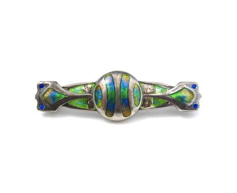 An Arts and Crafts silver and enamelled brooch, Smith and Ewen, Birmingham 1909, the central roundel with twin bar wings, in 