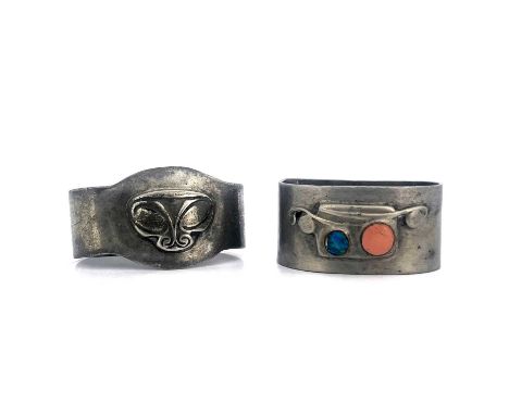 Archibald Knox for Liberty and Co., two Tudric Arts and Crafts pewter napkin rings, one with enamelled berry motifs, model 09