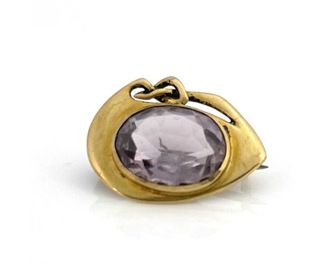 Archibald Knox for Liberty and Co. an Arts and Crafts gold and amethyst brooch, model 1287, circa 1903, the central facet cut
