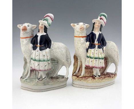 A pair of Staffordshire figures of royal children with sheep, circa 1860, modelled as royal portraits of the Prince of Wales 