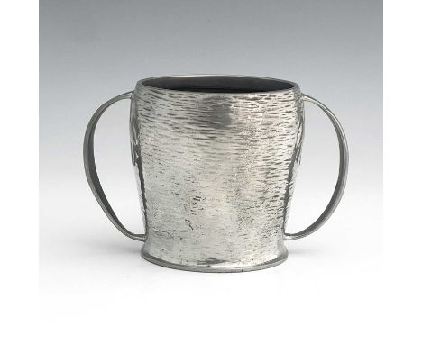 Archibald Knox for Liberty and Co., an Arts and Crafts Tudric pewter twin handled mug, model 0929, ogee horizontally textured