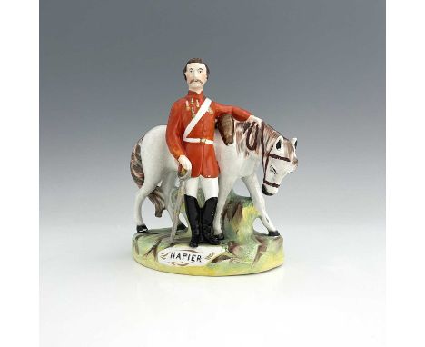 A Staffordshire figure of Sir Charles Napier, by Thomas Parr, circa 1870, modelled standing beside his horse, wearing an oran