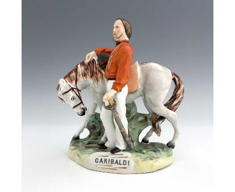 A Staffordshire figure of Garibaldi, by Thomas Parr, circa 1865, modelled standing beside his horse, wearing an orange jacket