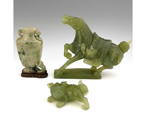 Three Chinese jade type carvings, including a horse, a sushi dog and a ring handled vase on stand, 21.5cm high