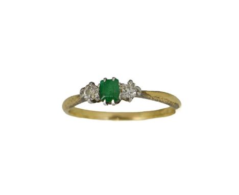 An 18ct gold, diamond and emerald ring, the central green stone flanked by two rose cut diamonds, size O, 2.1g