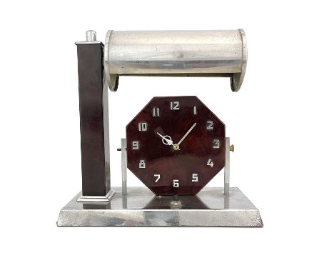 An Art Deco chrome and bakelite desk lamp clock, circa 1930, the octagonal face with applied Arabic numerals, below a tubular