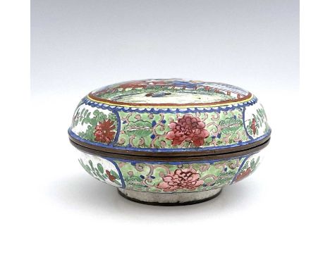 A Chinese Canton enamelled box and cover, circular bun form, painted with two boys by a fence in a garden, within foliate scr