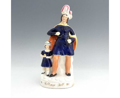 A Staffordshire figure of William Tell and his son, circa 1860, modelled as a flamboyantly dressed male figure standing besid