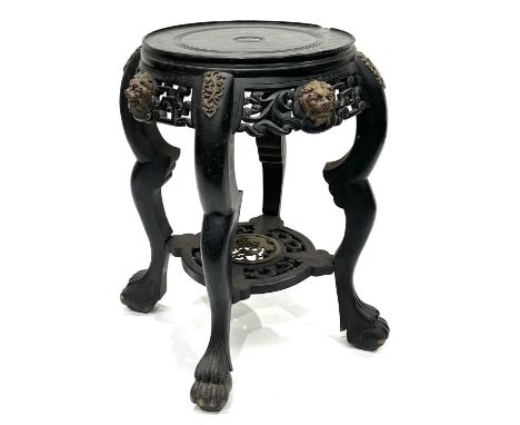 A Chinese ebonised jardiniere stand, late Qing Dynasty, scroll pierced frieze, gilt metal beast mask and scroll mounts, under