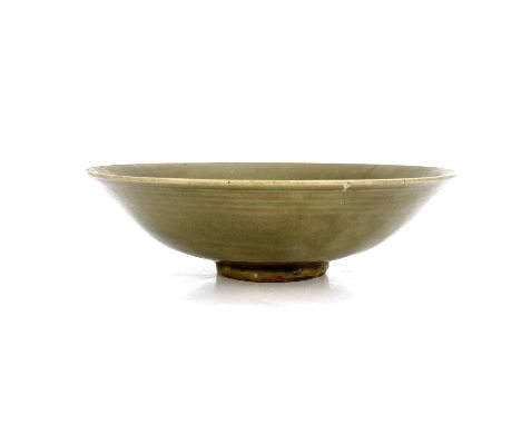 A Chinese celadon bowl, probably Northern Song, Yaozhou type, shallow everted rim, moulded ring and spoke decoration, 17.5cm 