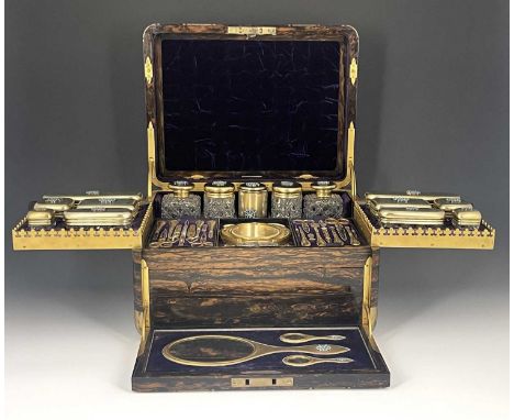 A Victorian fitted dressing case, of rounded rectangular form in brass bound coromandel, with recessed side carrying handles,