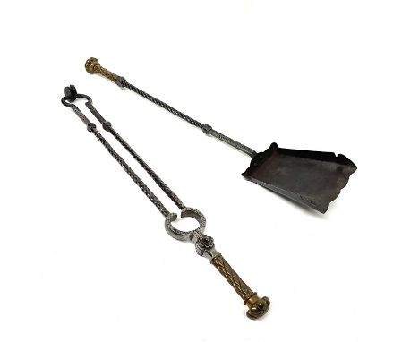 A pair of Gothic Revival brass and wrought steel fireside companion tools, including shovel and pincers, twisted stems with c