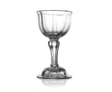 A pedestal sweetmeat glass, circa 1745, the vertically ribbed bell shaped bowl on a fluted inverse baluster stem with ring co