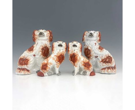 A Staffordshire figure group of spaniels, circa 1860, two matching pairs of seated Staffordshire spaniels, white enamel paint
