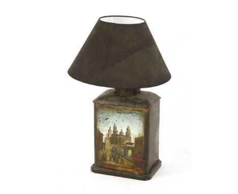 A painted tin tea canister,late 19th century, decorated with town scenes, converted for use as a table lamp, with black shade