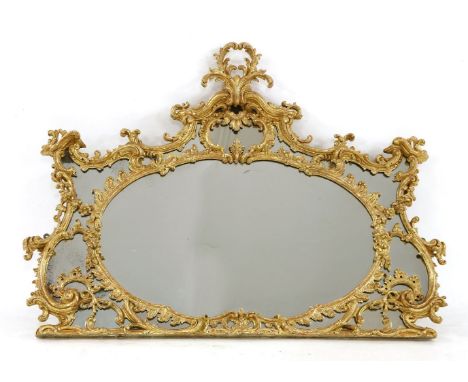 A Chippendale period giltwood overmantel,the shaped plate within an ornately carved frieze and mount with 'C' scrolls and sty