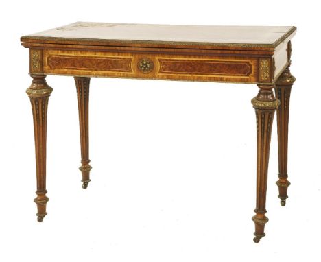 A French thuya, amboyna and inlaid fold-over card table,19th century, with gilt metal mounts, the underside with paper label: