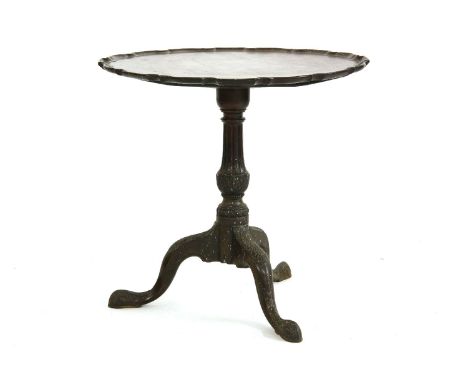 A George lll mahogany tripod table,the single piece dished top with a Chippendale-shaped border on an ornately carved base, a