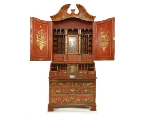 A red lacquered bureau bookcase,George ll and later, the top section with a swan neck pediment over two panelled doors, enclo