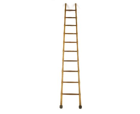 A wooden library ladder,with ten turned rungs,275cm high