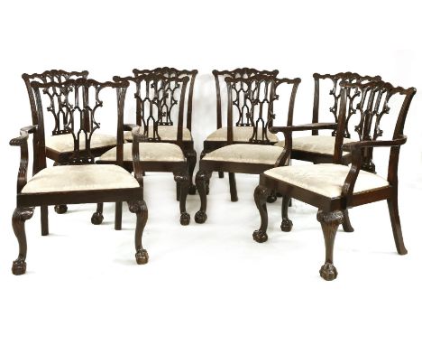 A set of eight Chippendale-style mahogany dining chairs, the shaped top rails with carved bell decoration, over ornately pier