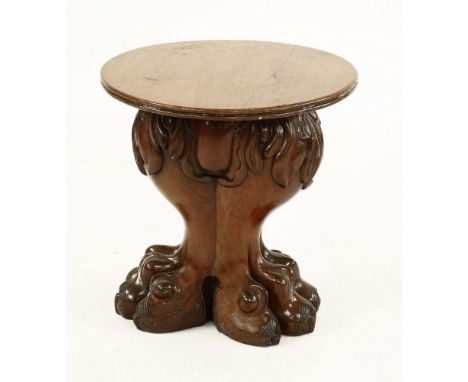 A mahogany lamp table,early 20th century, the moulded circular top over an extravagantly carved base in the form of two conjo